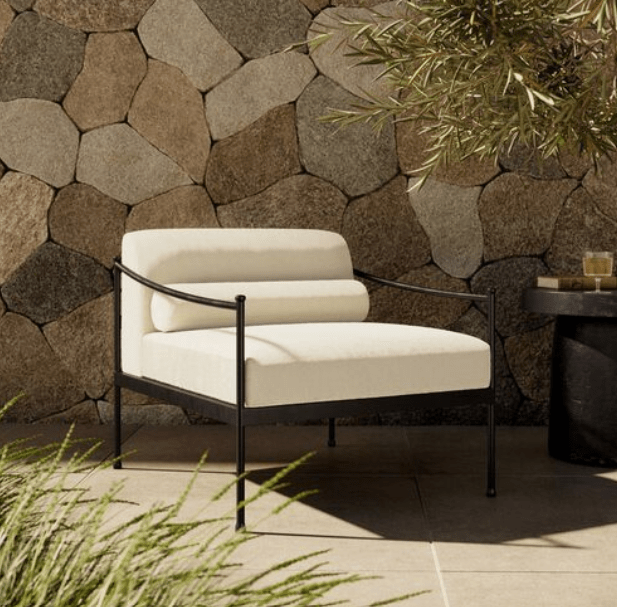 French vintage inspiration embodies the streamlined silhouette of this outdoor chair. A low profile with understated turned leg details supports washable cushions, complemented with a bolster back pillow for an updated look. Cover or store inside during inclement weather and when not in use.