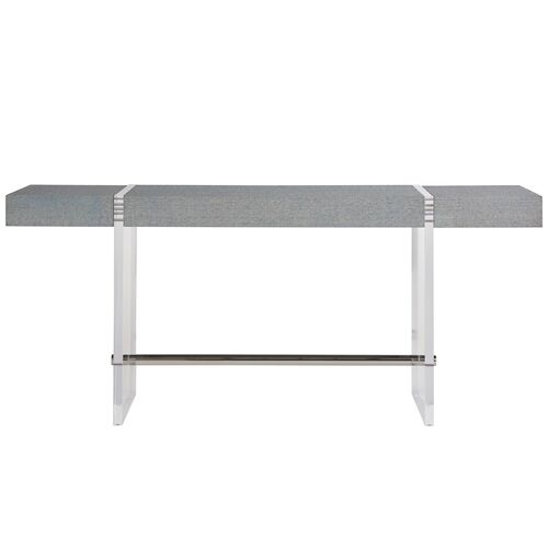  a chic and adaptable piece featuring a spacious polished top, modern acrylic legs, and a striking silver lower beam