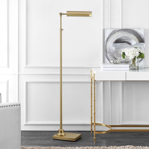 A timeless addition to a library, a den, or a reading nook, this golden floor lamp can adjust in height from 55 to 64.5 inches.