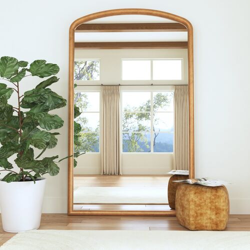 understated elegance of the Harrington Arched Leaner Floor Mirror. Inspired by classic European design, this tall floor mirror features a graceful curved top and a grounded rectangular base, offering a harmonious balance of form and proportion. The gilded bronze finish adds a soft metallic warmth, lending a refined touch to both traditional and modern interiors.