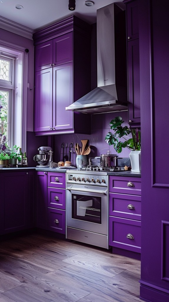 “Vibrant purple kitchen cabinets with modern stainless‑steel range and chimney hood, purple color‑drenched walls, black stone countertop, potted herbs by sunlit window, brushed nickel cup pulls, and warm gray wood flooring—bold jewel‑tone violet kitchen renovation inspiration for contemporary homes.”

